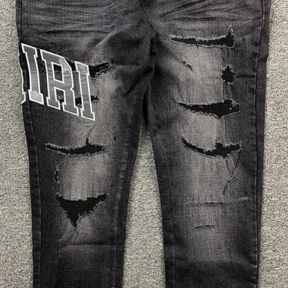 AMIRI VARSITY LOGO REPAIR JEANS